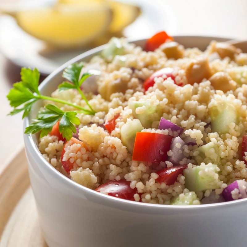 Moroccan Couscous Salad in a white bowl with garnish