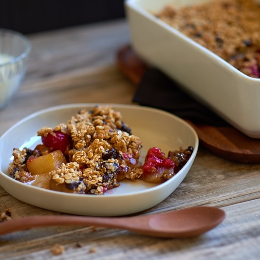 Raspberry and Pear Dark Chocolate Crumble on a Wooden Table Photo