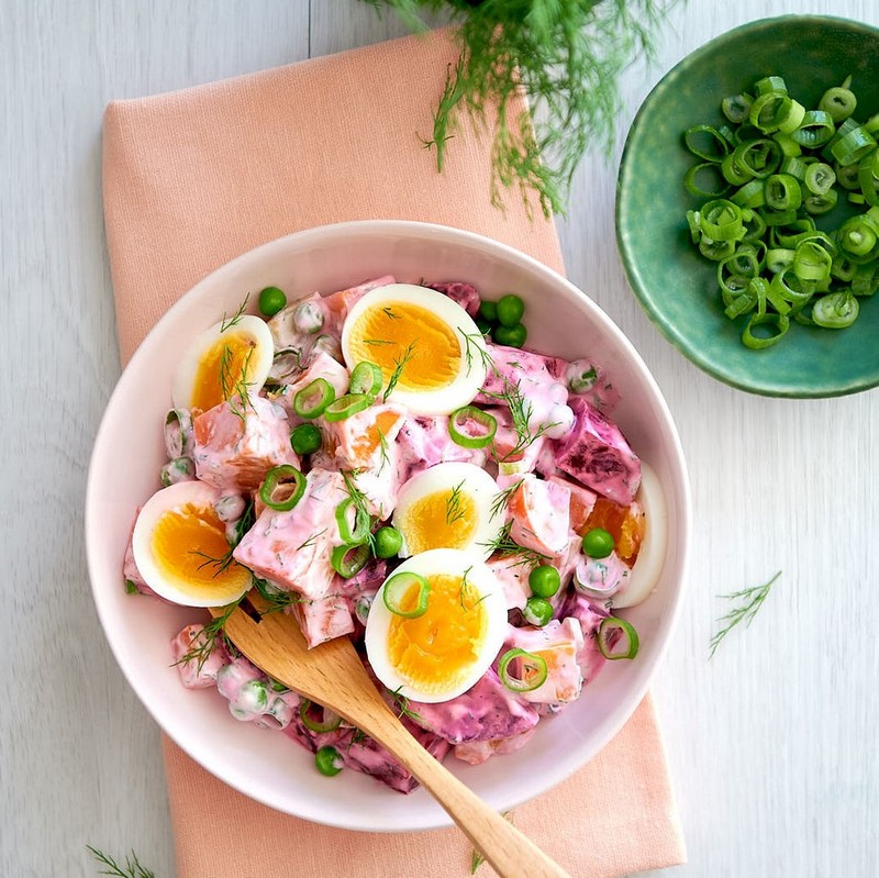 Bowl of Red Salad on a light wooden table photo