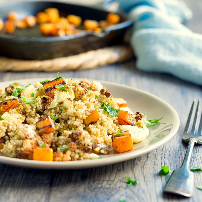 Roasted Pumpkin and Quinoa Salad on a Blue Wooden Table Photo