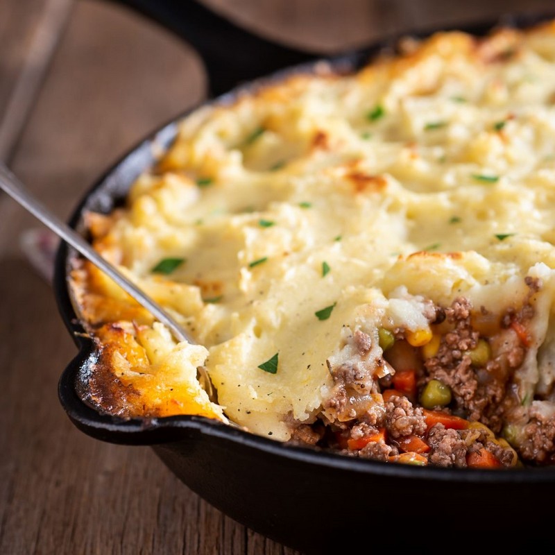 Shepherds Pie on Wooden Table Close Up Photo