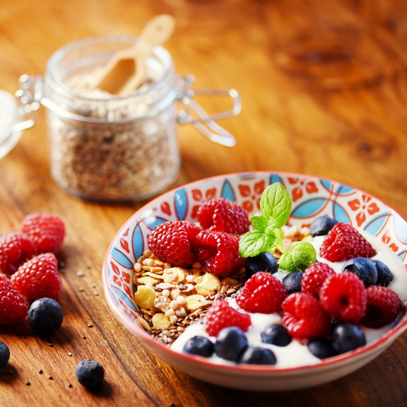 Sulatana and Pepita Muesli bowl on a wooden table